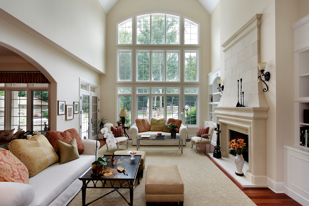 Design ideas for a traditional family room in Denver with dark hardwood floors and a stone fireplace surround.