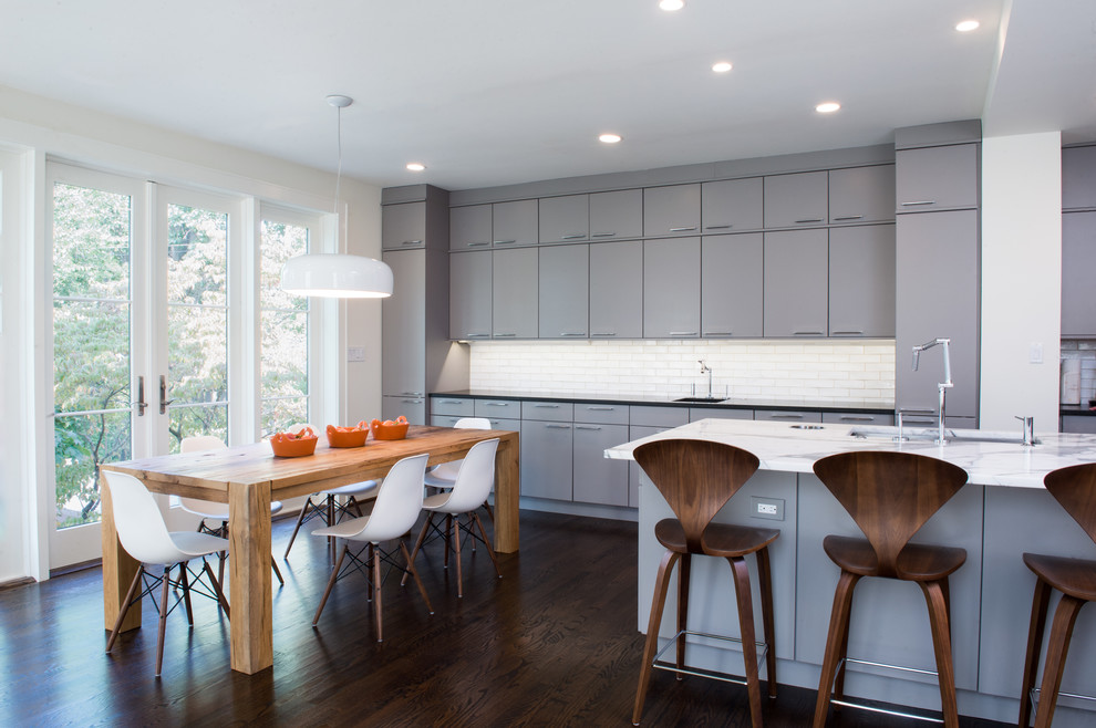 Contemporary galley eat-in kitchen in DC Metro with an undermount sink, flat-panel cabinets, grey cabinets, marble benchtops, white splashback and subway tile splashback.