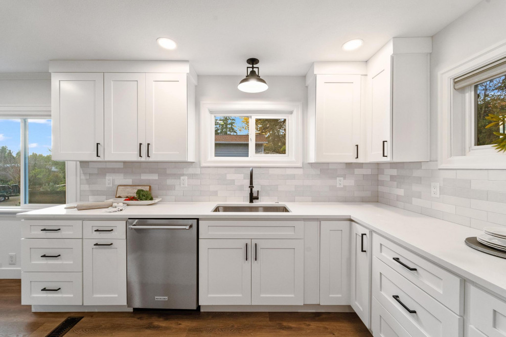 Inspiration for a transitional galley dark wood floor and brown floor eat-in kitchen remodel in Seattle with an undermount sink, shaker cabinets, white cabinets, quartzite countertops, gray backsplash, ceramic backsplash, stainless steel appliances, no island and white countertops