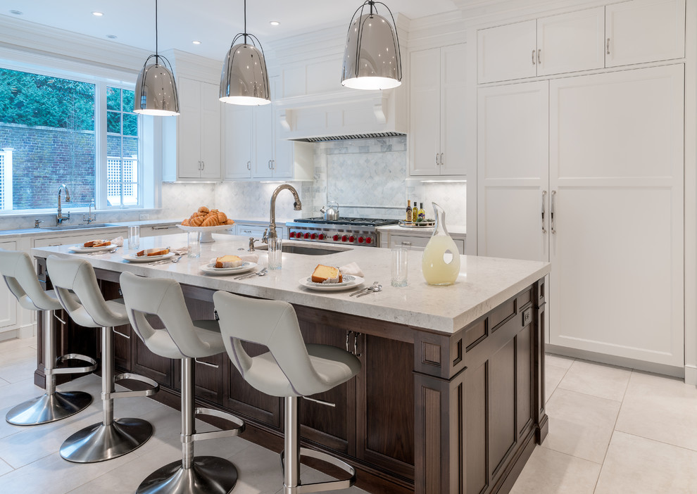 Design ideas for a transitional u-shaped kitchen in Boston with an undermount sink, shaker cabinets, white cabinets, white splashback, stainless steel appliances and with island.