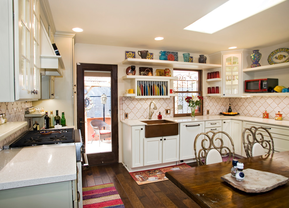 Photo of a separate kitchen in Austin with a farmhouse sink, open cabinets, white cabinets and white splashback.