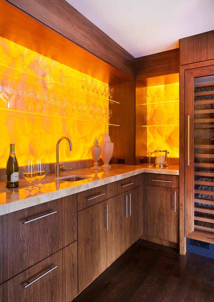 This is an example of a mid-sized contemporary home bar in Boston with an undermount sink, flat-panel cabinets, dark wood cabinets, yellow splashback and dark hardwood floors.