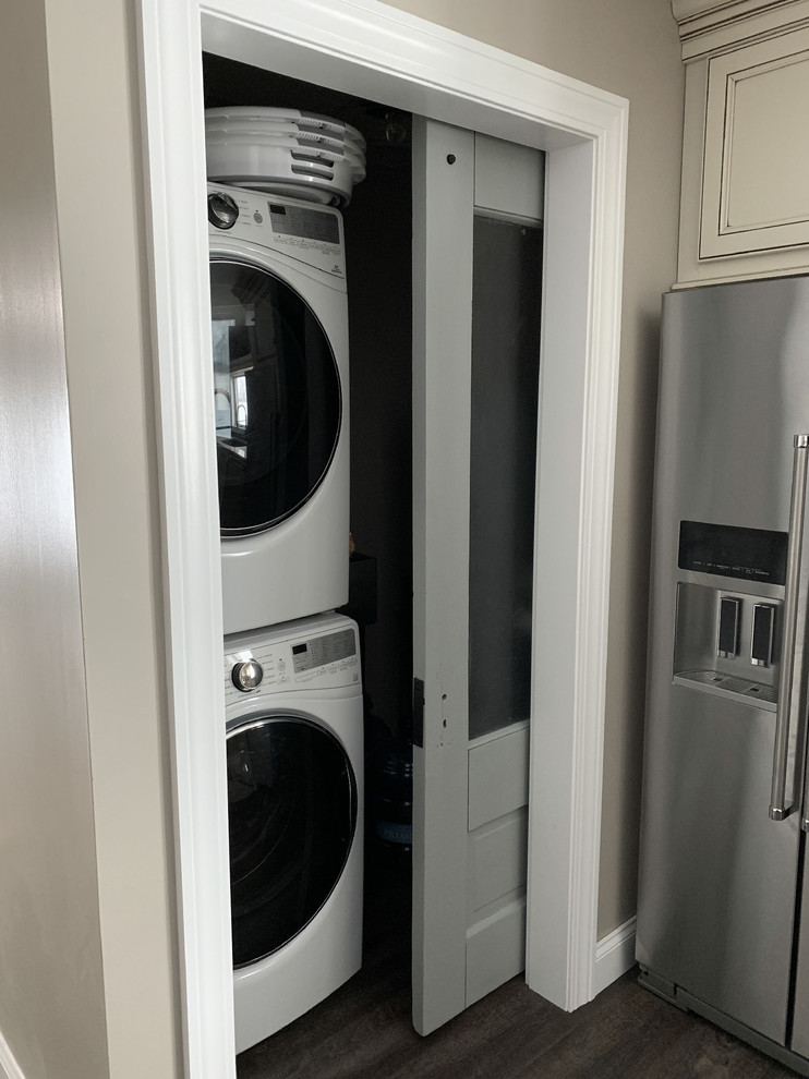 Large transitional l-shaped laundry room in Other with an undermount sink, recessed-panel cabinets, white cabinets, granite benchtops, grey splashback, ceramic splashback and multi-coloured benchtop.