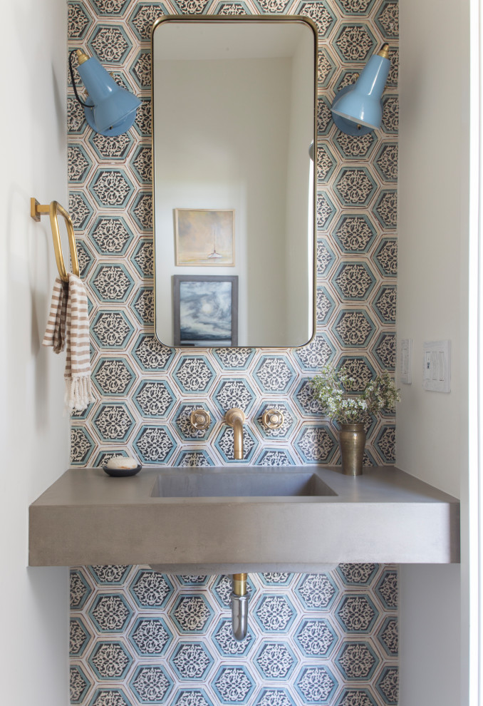Inspiration for a beach style powder room in DC Metro with multi-coloured tile, grey walls, an integrated sink and grey benchtops.