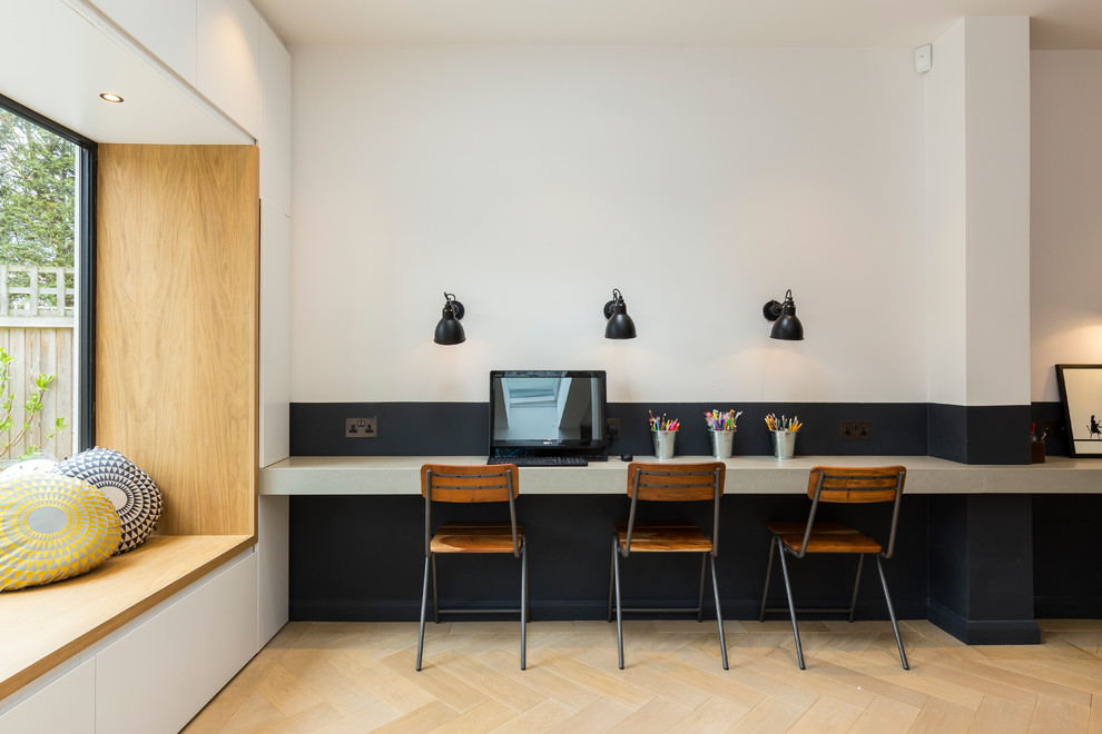 Design ideas for a contemporary gender-neutral kids' study room in London with multi-coloured walls and light hardwood floors.