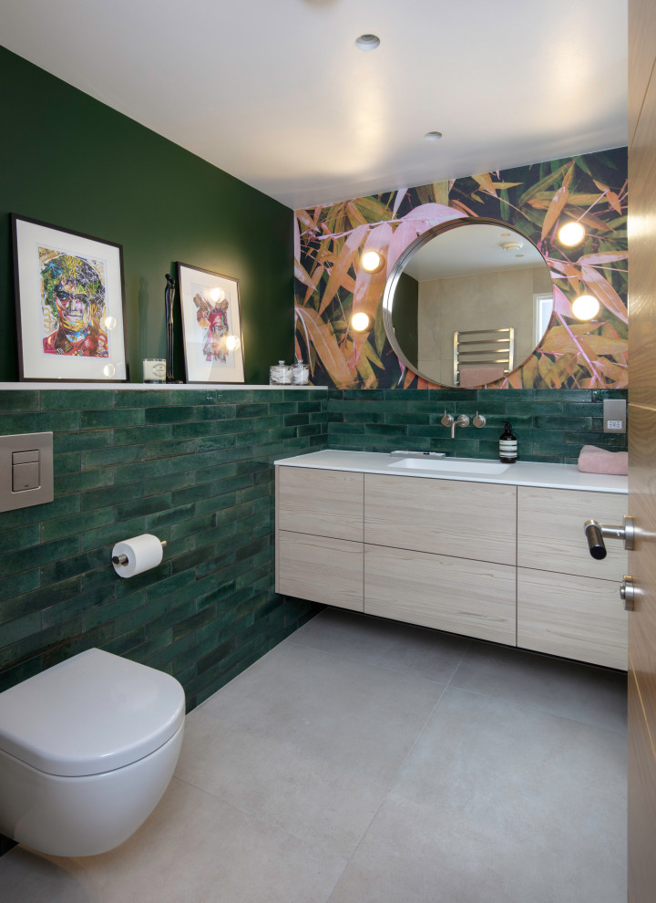 Inspiration for a mid-sized modern green tile and subway tile porcelain tile and single-sink bathroom remodel in London with flat-panel cabinets, light wood cabinets, green walls, a drop-in sink and a floating vanity