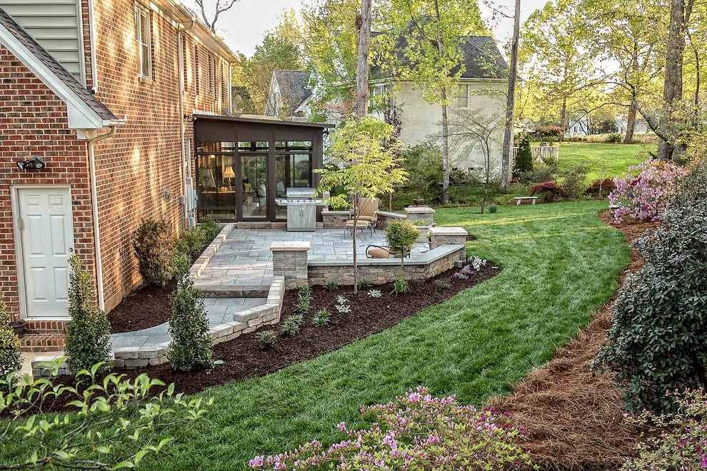 Inspiration for a mid-sized traditional backyard patio in Raleigh with concrete pavers and no cover.