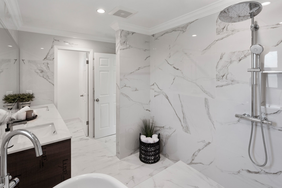 Photo of a large modern master wet room bathroom in San Francisco with flat-panel cabinets, brown cabinets, a freestanding tub, a one-piece toilet, gray tile, marble, white walls, marble floors, an undermount sink, marble benchtops, grey floor, an open shower, grey benchtops, an enclosed toilet, a double vanity and a floating vanity.