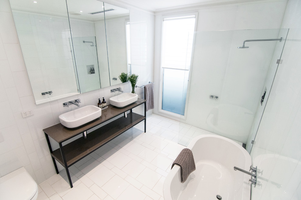 Contemporary bathroom in Melbourne with a curbless shower and a wall-mount toilet.