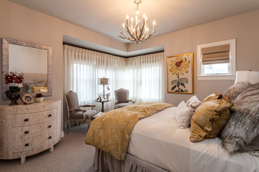 This is an example of a mid-sized transitional master bedroom in Denver with beige walls and carpet.