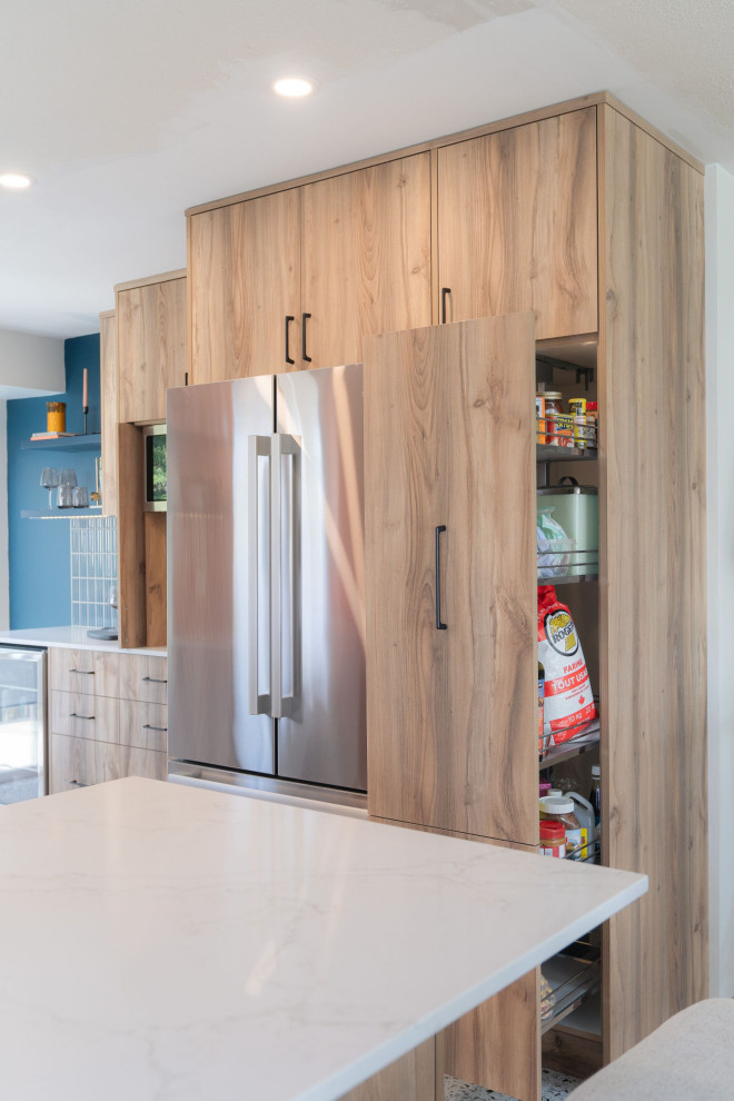 Example of a small transitional u-shaped terrazzo floor and white floor eat-in kitchen design in Vancouver with a farmhouse sink, flat-panel cabinets, light wood cabinets, quartz countertops, blue backsplash, porcelain backsplash, stainless steel appliances, an island and white countertops