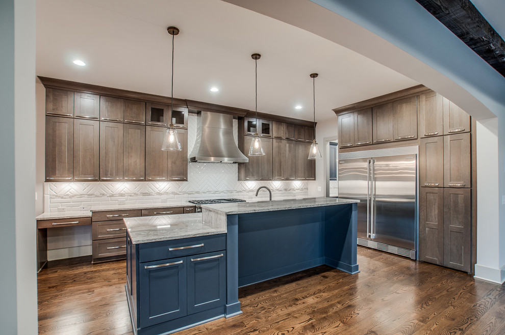 Mid-sized transitional l-shaped dark wood floor and brown floor enclosed kitchen photo in Nashville with shaker cabinets, dark wood cabinets, granite countertops, white backsplash, porcelain backsplash, stainless steel appliances, an island and an undermount sink