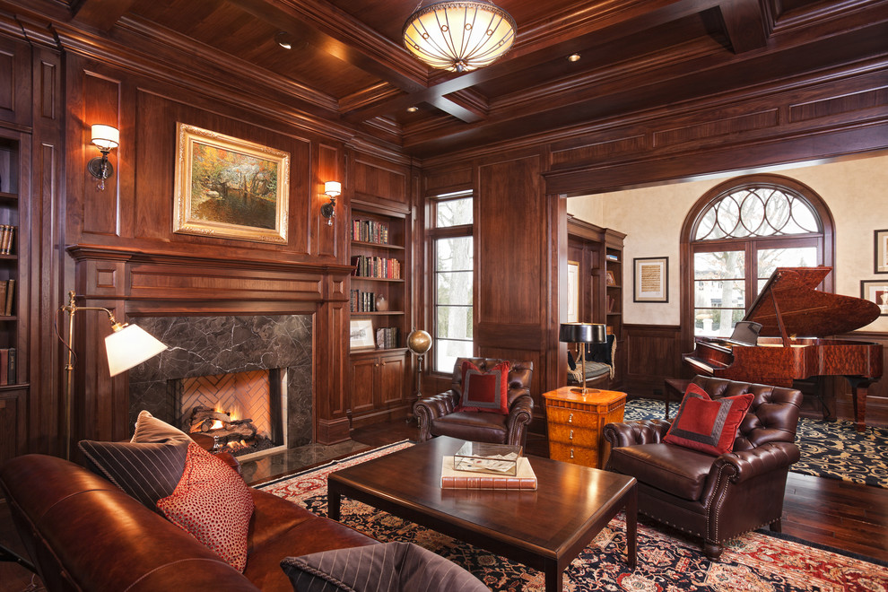 Design ideas for a traditional family room in Minneapolis with a library, brown walls, dark hardwood floors, a standard fireplace, a stone fireplace surround and no tv.