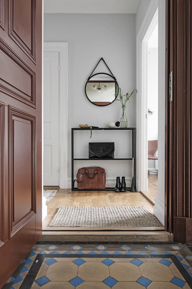Inspiration for a traditional hallway in Gothenburg with white walls and medium hardwood floors.