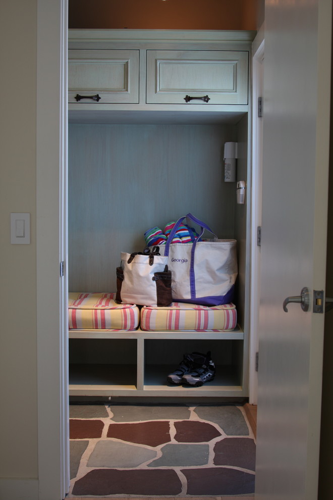 Example of a mid-sized mountain style multicolored floor mudroom design in Los Angeles with orange walls