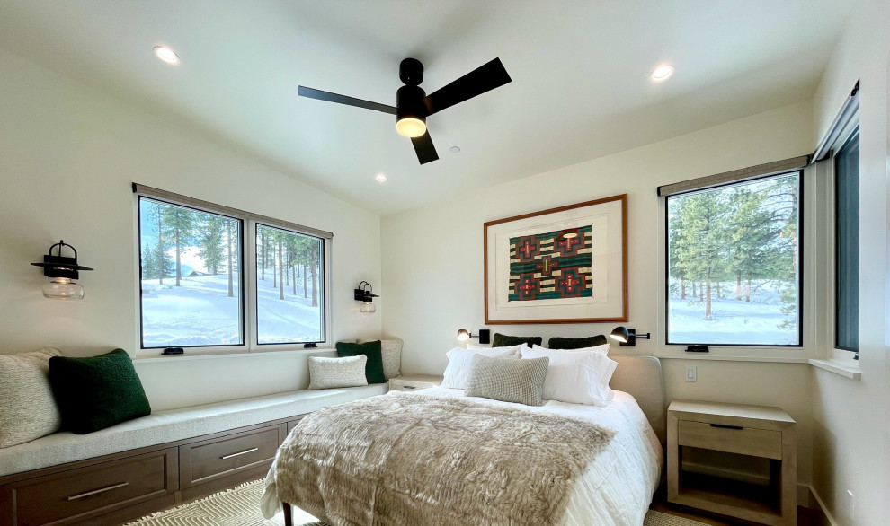 Example of a mid-sized mountain style guest light wood floor and brown floor bedroom design with beige walls