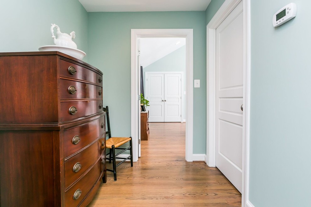 Design ideas for a mid-sized traditional hallway in Baltimore with blue walls and medium hardwood floors.