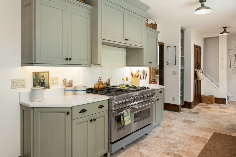 Photo of an expansive u-shaped eat-in kitchen in Philadelphia with a farmhouse sink, recessed-panel cabinets, green cabinets, quartz benchtops, engineered quartz splashback, stainless steel appliances and with island.