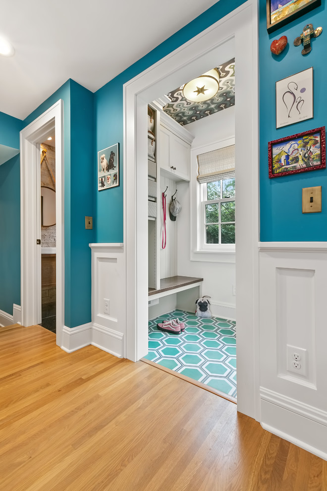 Design ideas for a mid-sized eclectic mudroom in Minneapolis with grey walls, green floor and a white front door.