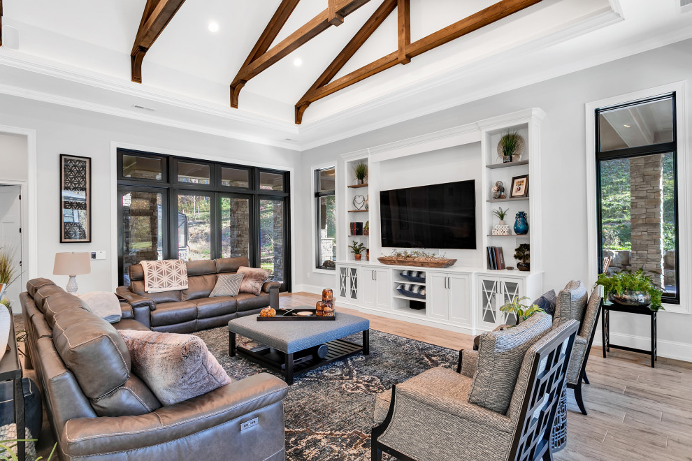 Expansive modern open plan games room in Other with a game room, grey walls, ceramic flooring, no fireplace, a built-in media unit, grey floors and exposed beams.