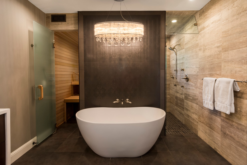 Photo of a contemporary master bathroom in Seattle with a freestanding tub, a curbless shower, beige tile, stone tile and a hinged shower door.