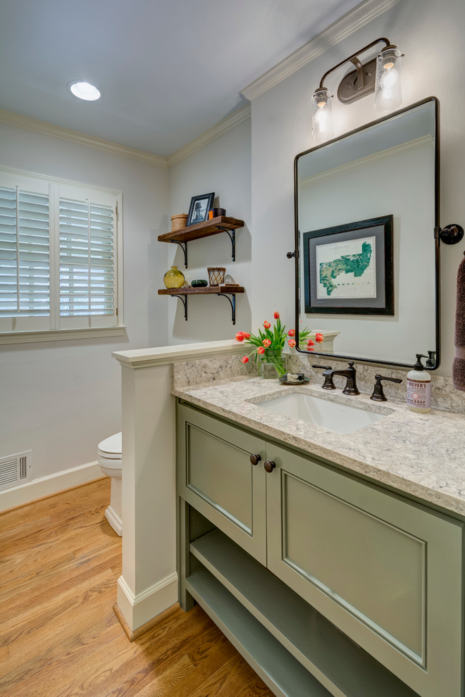 Small traditional 3/4 bathroom in Atlanta with beaded inset cabinets, green cabinets, white walls, medium hardwood floors, an undermount sink and engineered quartz benchtops.