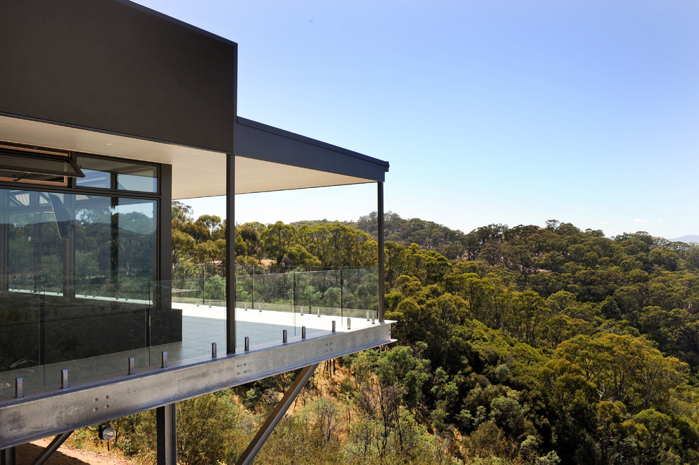 Design ideas for a contemporary one-storey exterior in Melbourne with stone veneer.