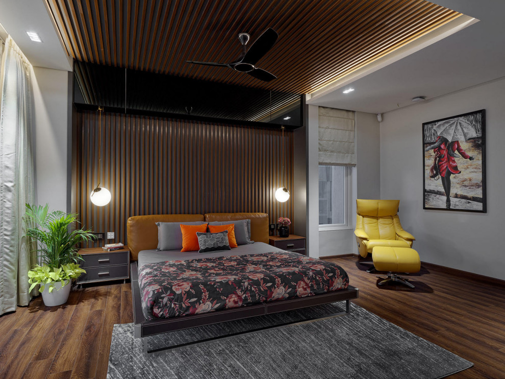 This is an example of a large contemporary master bedroom in Pune with white walls, grey floor, wood and wood walls.