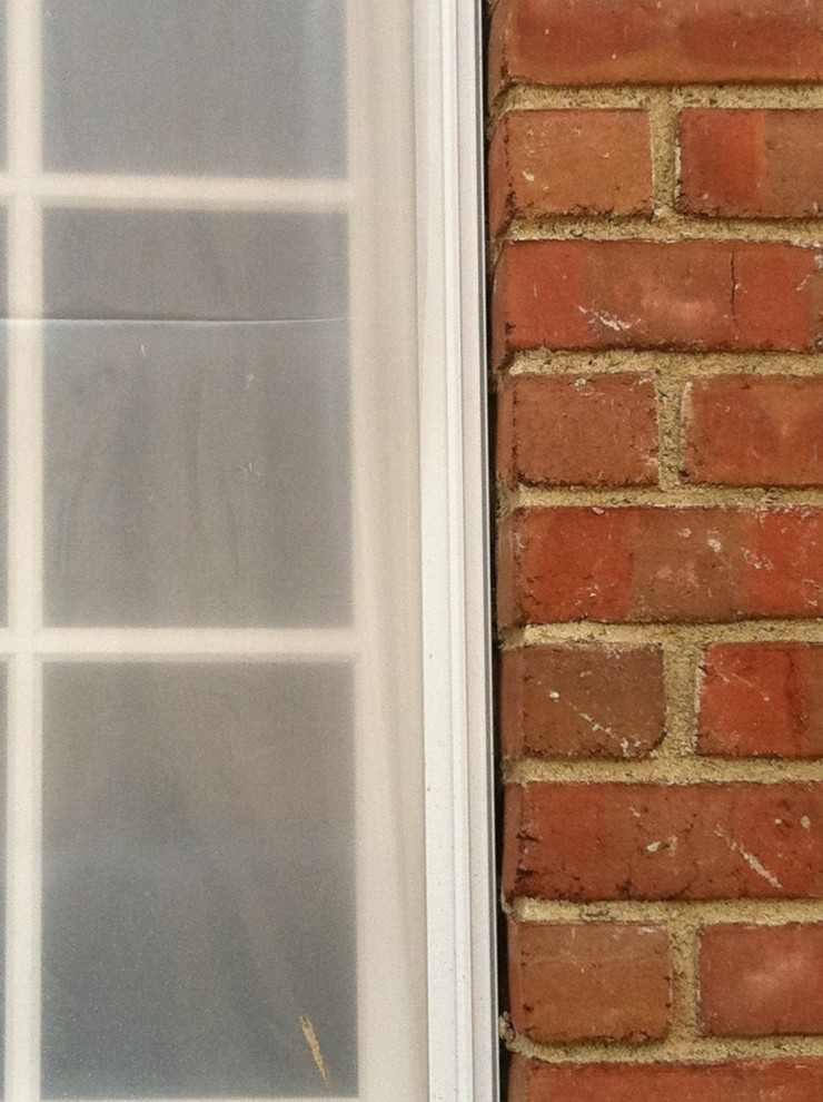 Is caulking an acceptable filler between windows and brick here?