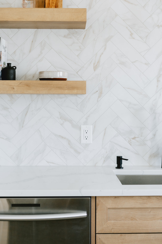 Inspiration for a transitional single-wall vinyl floor and brown floor kitchen remodel in Edmonton with shaker cabinets, quartz countertops, white backsplash, ceramic backsplash, stainless steel appliances, an island and white countertops