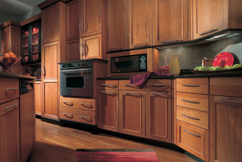 Open concept kitchen - large transitional u-shaped medium tone wood floor and beige floor open concept kitchen idea in Orange County with quartz countertops, subway tile backsplash, stainless steel appliances, an island, recessed-panel cabinets, medium tone wood cabinets and brown backsplash