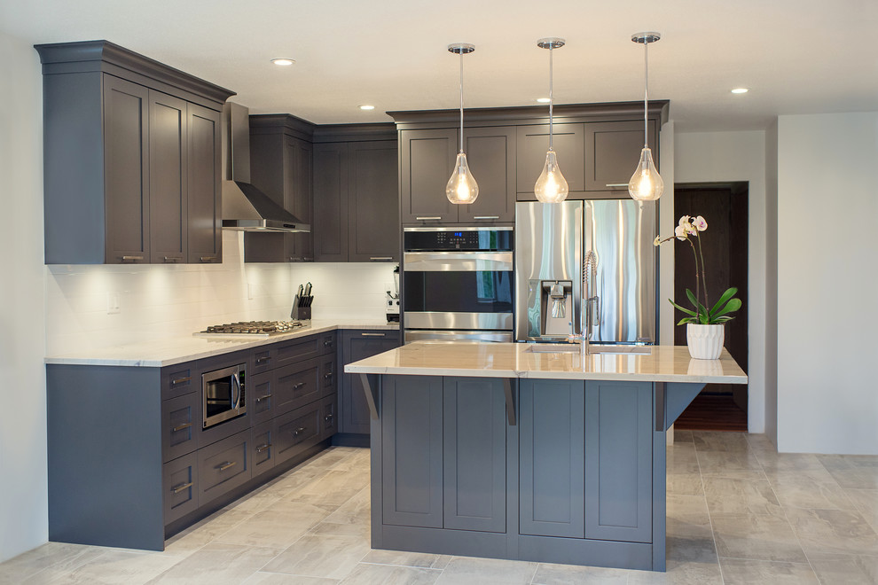 Eat-in kitchen - mid-sized transitional l-shaped eat-in kitchen idea in Vancouver with a single-bowl sink, shaker cabinets, gray cabinets, marble countertops, white backsplash, stainless steel appliances and an island