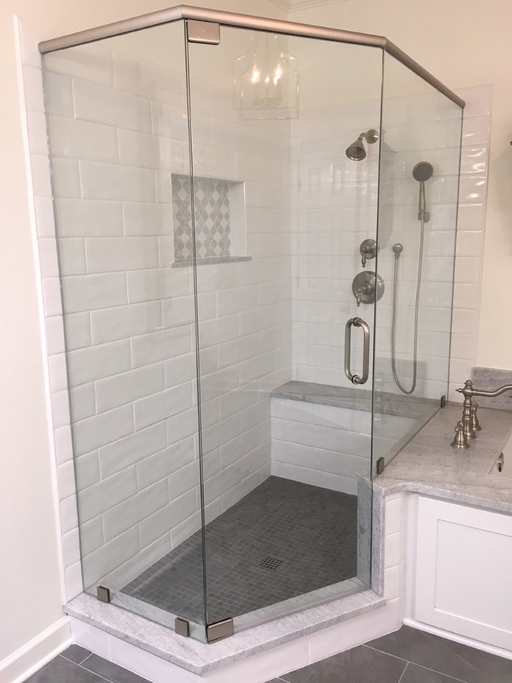 Example of a mid-sized transitional master white tile and ceramic tile porcelain tile and gray floor corner shower design with recessed-panel cabinets, white cabinets, an undermount tub, a two-piece toilet, gray walls, an undermount sink, marble countertops and a hinged shower door