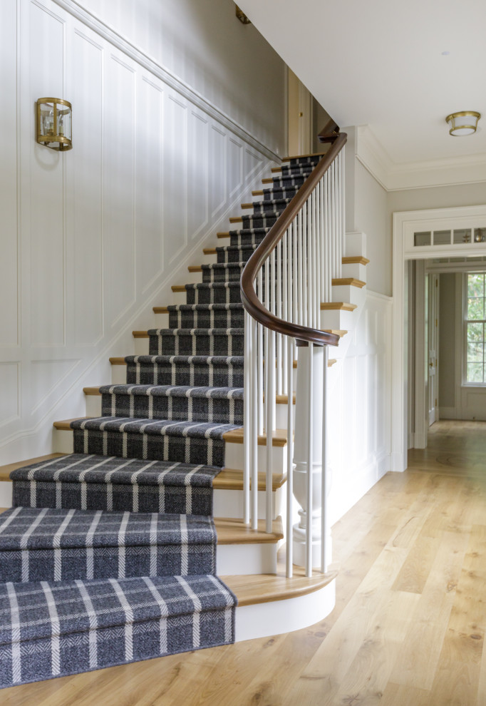 This is an example of a traditional curved staircase in Minneapolis with wood railing.