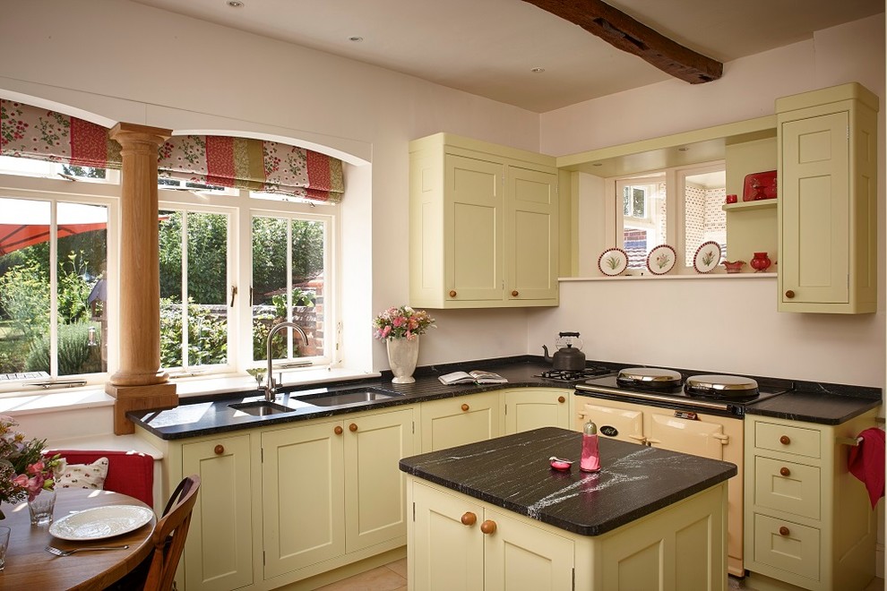 Small country eat-in kitchen in Surrey with an undermount sink, shaker cabinets, green cabinets, granite benchtops, limestone floors and with island.