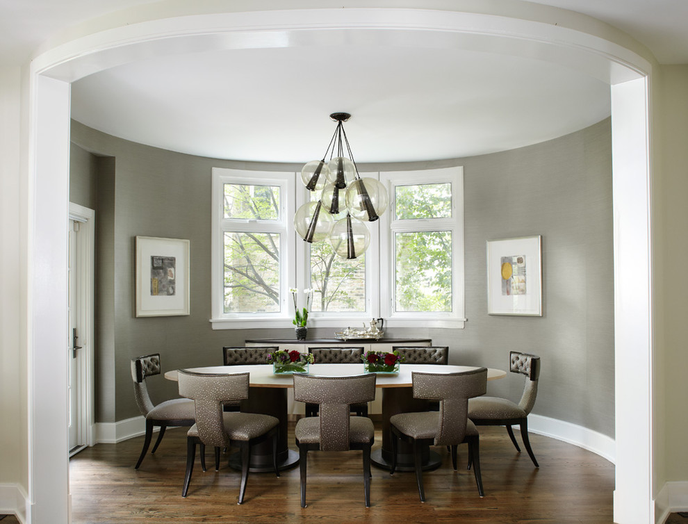 This is an example of a contemporary separate dining room in Chicago with grey walls and dark hardwood floors.