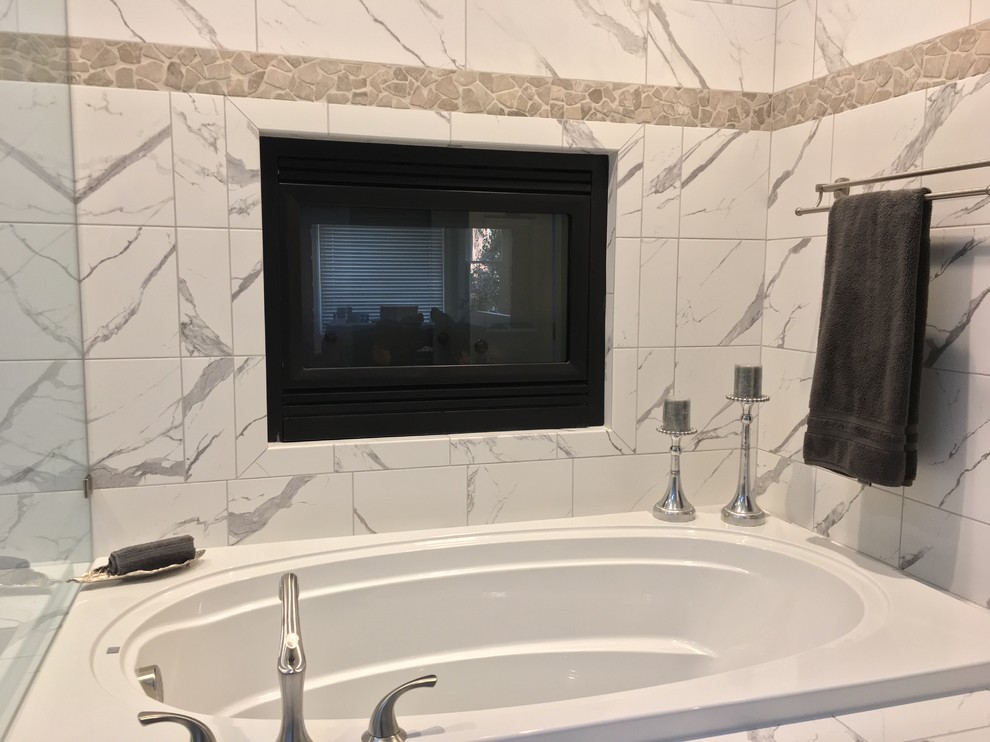 Design ideas for a mid-sized transitional master bathroom in Raleigh with raised-panel cabinets, grey cabinets, a drop-in tub, a two-piece toilet, black and white tile, porcelain tile, grey walls, porcelain floors, an undermount sink and granite benchtops.