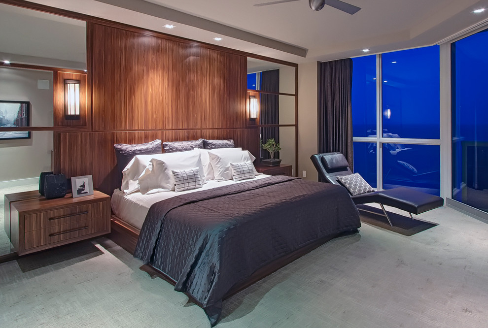 This is an example of a mid-sized contemporary master bedroom in Miami with carpet.