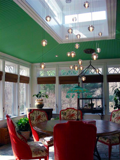 Photo of a mid-sized eclectic separate dining room in New York with green walls, carpet and no fireplace.