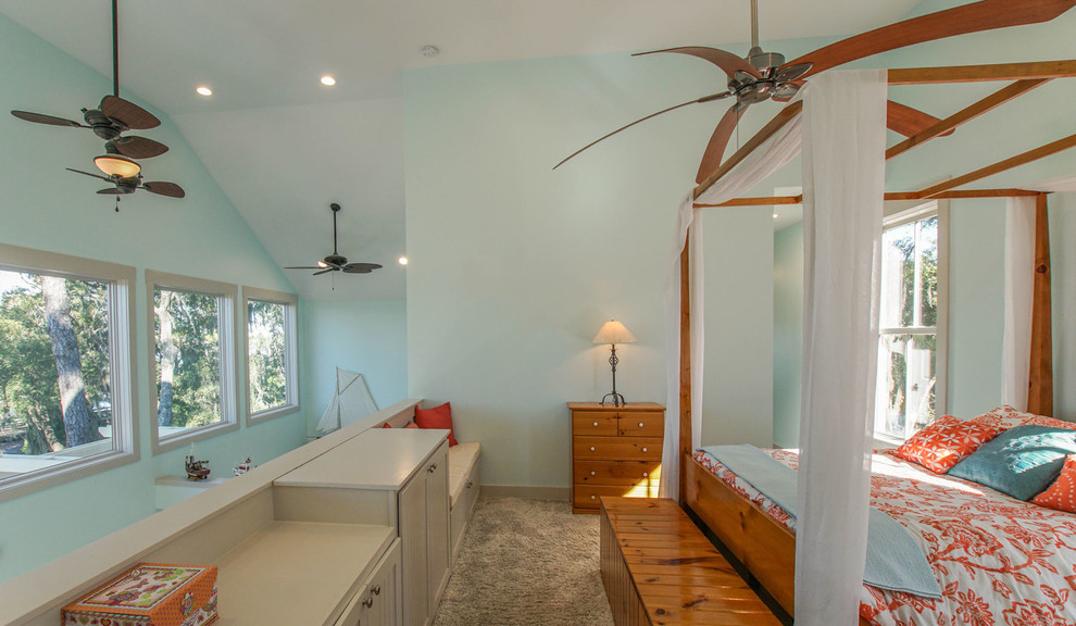 Large beach style master bedroom in Charleston with blue walls, carpet and no fireplace.