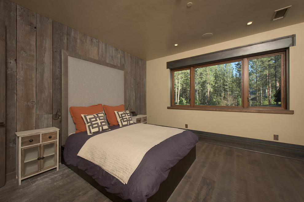 Photo of a large industrial guest bedroom in Other with beige walls and medium hardwood floors.