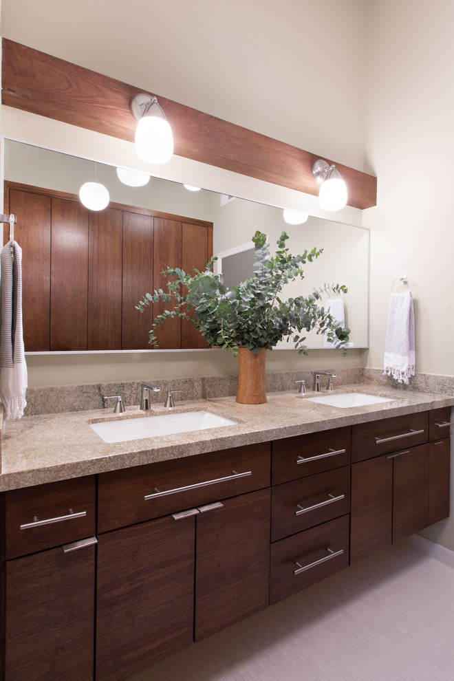 Photo of a large midcentury bathroom in Denver with an undermount sink, flat-panel cabinets, medium wood cabinets, granite benchtops, an alcove tub, a shower/bathtub combo, a two-piece toilet, white tile, porcelain tile, white walls and porcelain floors.