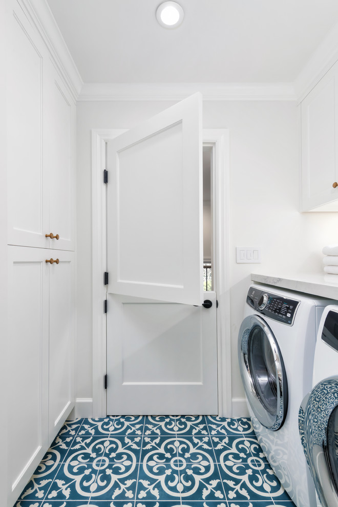 Photo of a small country l-shaped dedicated laundry room in San Francisco with a farmhouse sink, beaded inset cabinets, white cabinets, quartz benchtops, white walls, ceramic floors, a side-by-side washer and dryer, blue floor and white benchtop.
