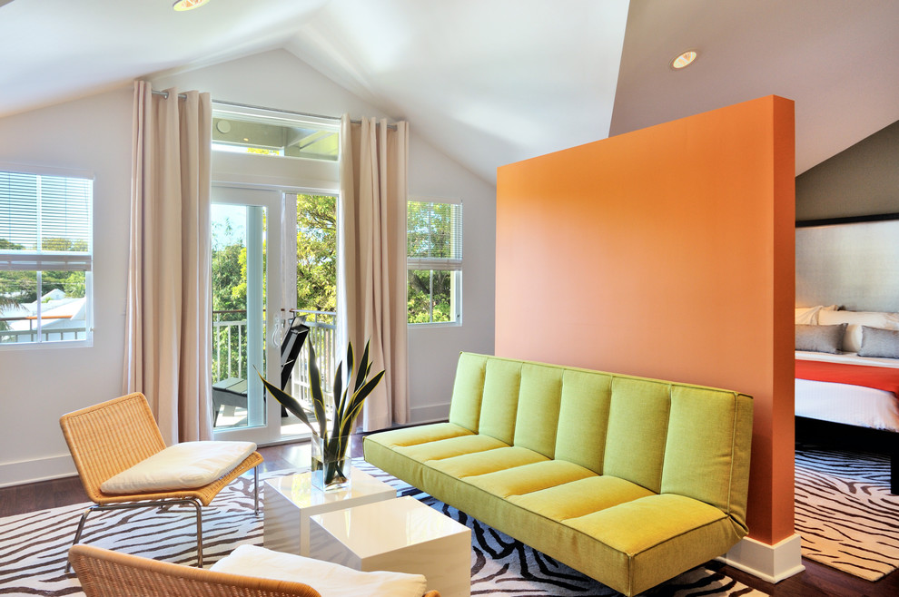 Design ideas for a contemporary bedroom in Miami with orange walls.