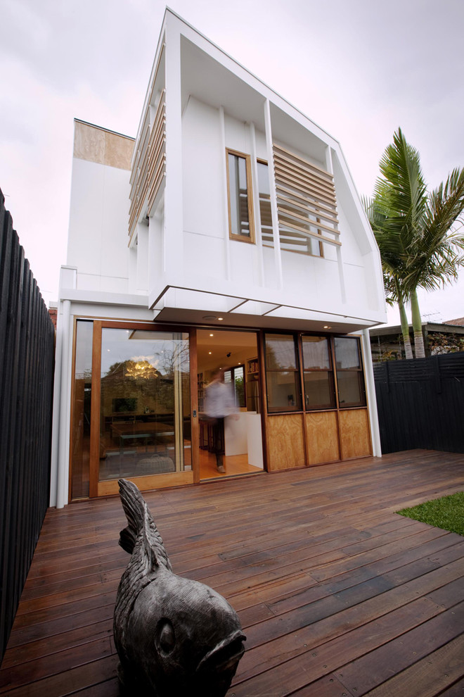 Inspiration for a contemporary one-storey white exterior in Melbourne with wood siding.