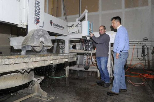 Our team cutting a slab of granite