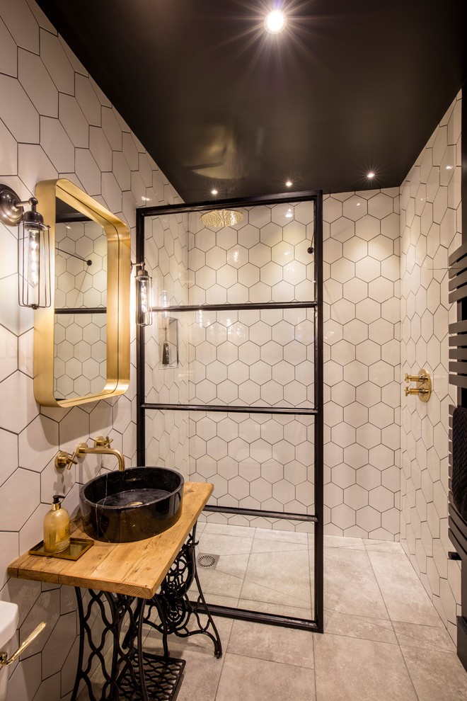 This is an example of a mid-sized eclectic 3/4 bathroom in London with white tile, white walls, a vessel sink, wood benchtops, grey floor, an open shower, a curbless shower and brown benchtops.