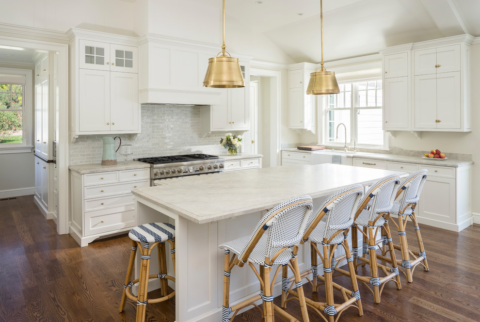 Design ideas for a traditional kitchen in Salt Lake City with a farmhouse sink, shaker cabinets, white cabinets, grey splashback, stainless steel appliances, dark hardwood floors, with island and brown floor.