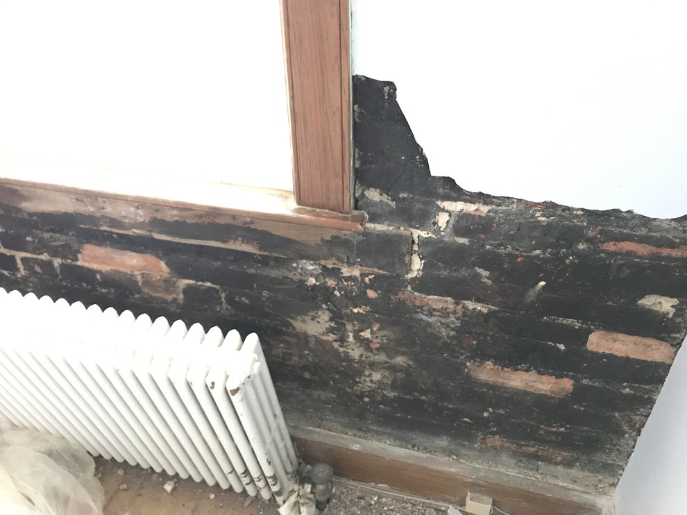 what is the black thing behind plaster wall?