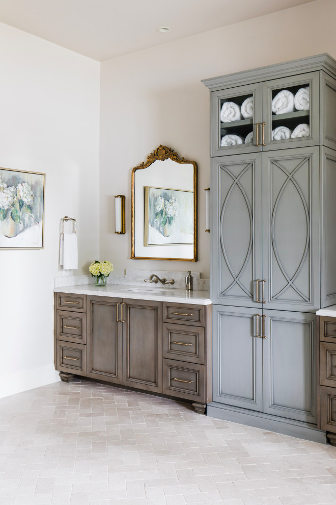 Photo of a mediterranean bathroom in Phoenix with recessed-panel cabinets, blue cabinets, a freestanding tub, an alcove shower, limestone floors, marble benchtops, a hinged shower door, a double vanity, a built-in vanity and coffered.